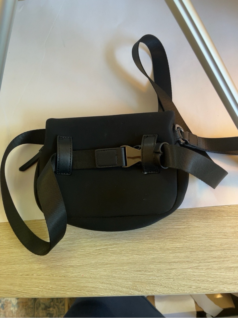 Sleek Black Crossbody Saddle Bag with Metal Buckle